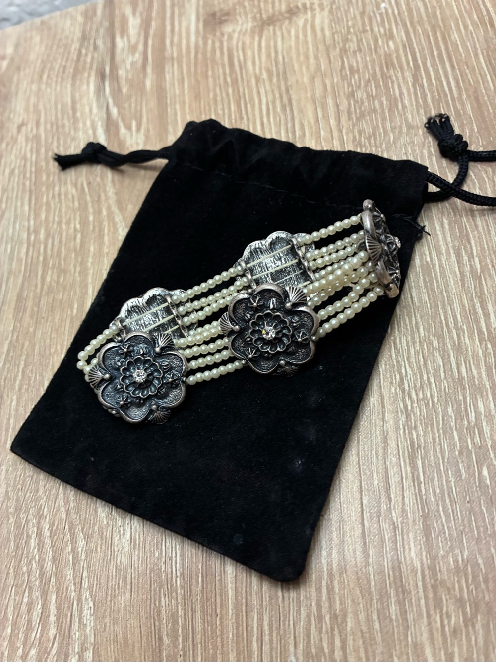 Multi-strand vintage faux pearl bracelet featuring antique filigree florals